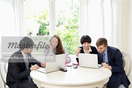 Group of businesspeople working on laptop