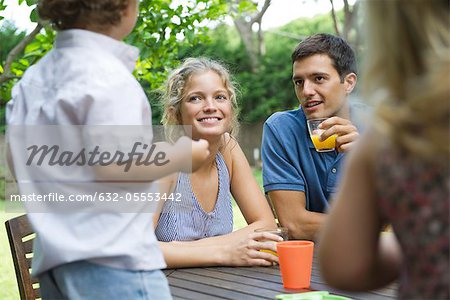 Family relaxing together at outdoor table