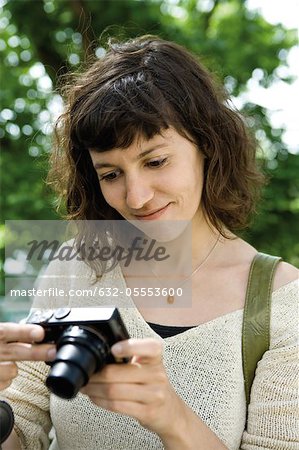 Woman looking at digital camera