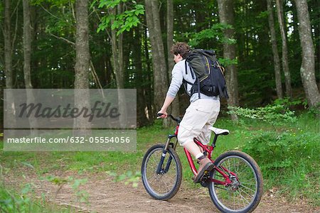 Mountain biker riding through woods
