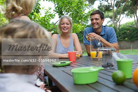 Family relaxing together at outdoor table