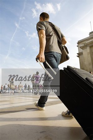 Man walking with rolling luggage