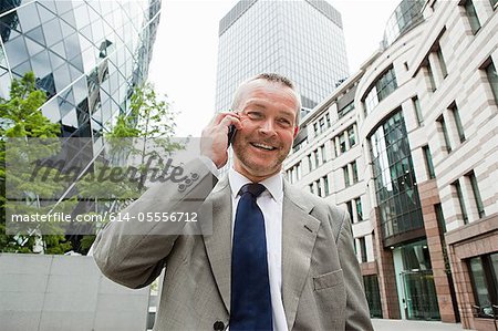 Businessman in city on cellphone