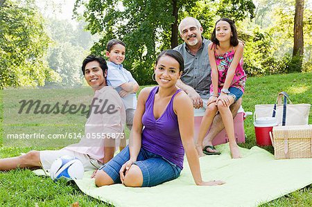 Three generation family at picnic in park, portrait