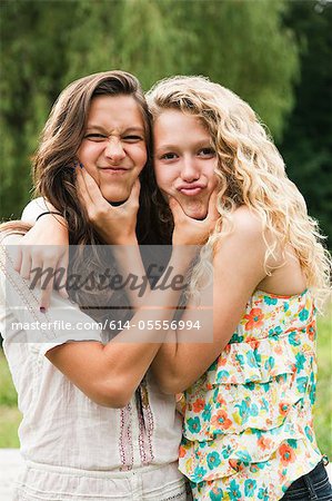 Two teenage girls fooling around and making faces