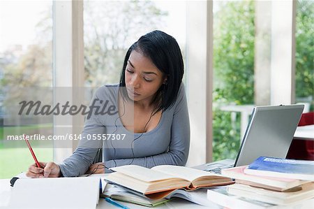 University student writing at desk