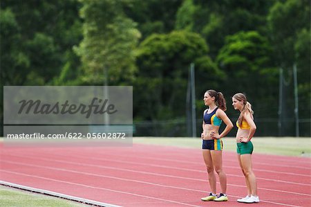 Two Female Runners On Race Track
