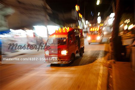 Speeding vans on main road at night