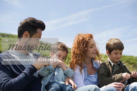 Parents and young boys playing in nature