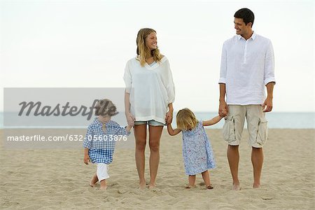 Family holding hands at the beach