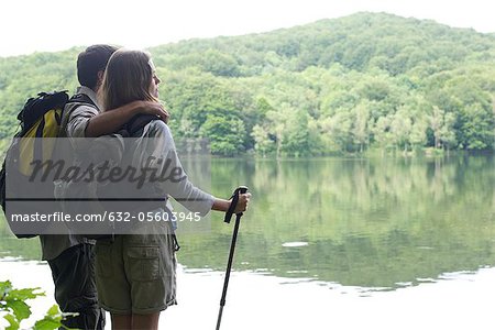 Hiking couple standing by lake