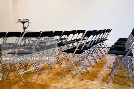 Folding chairs lined up in conference room