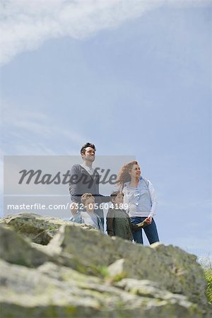 Parents and young boys standing in nature