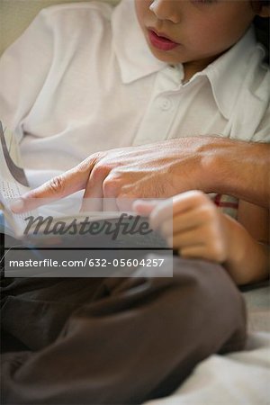 Boy learning to read, cropped