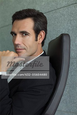 Executive with hand under chin, portrait