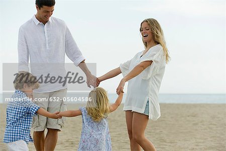 Family holding hands at the beach