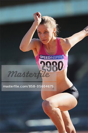 Young Female Athlete Performing High Jump