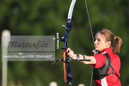 Young Female Archer Aiming at Target