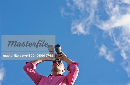 Man Looking through Binoculars