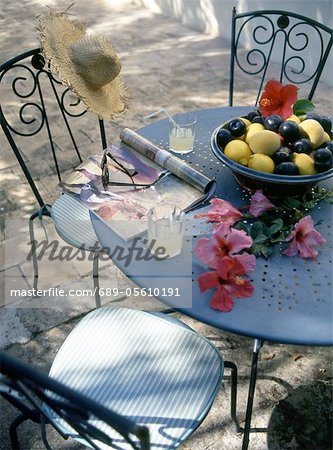 Garden table with hibiscus flowers and fruit bowl