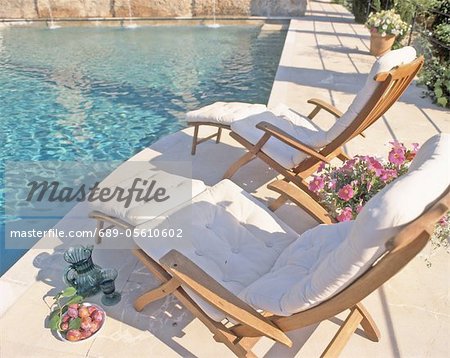 Two deckchairs by the poolside