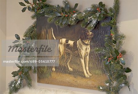 Painting of a dog surrounded by fir branches