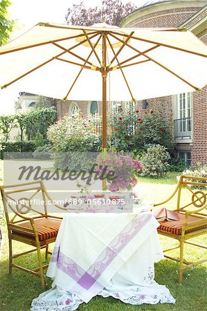 Sitting area in garden with sunshade