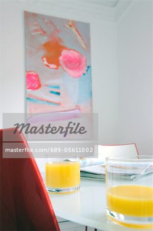 Glasses with orange juice on dining table