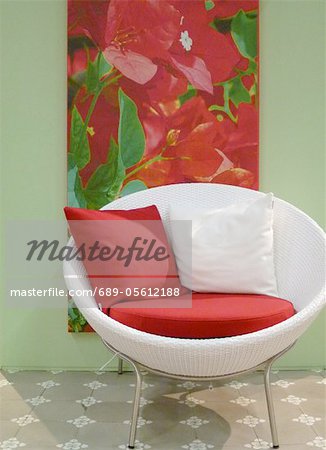 White armchair and picture of a flower