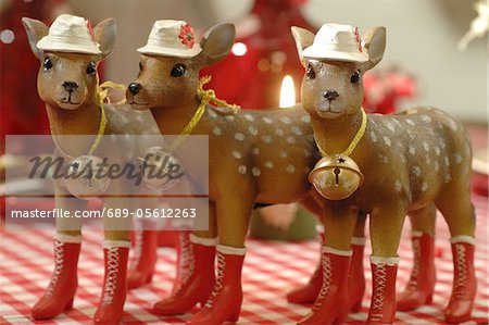 Three Christmas deer figurines standing in row