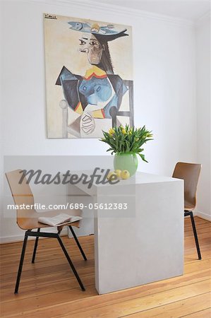 Painting above table with bunch of flowers