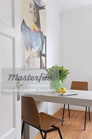 Painting above table with bunch of flowers