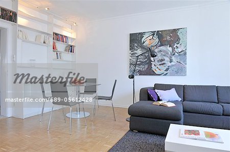 Modern living room with painting and dining area