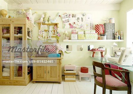 Room with cabinet, cuddly toys, storage boxes and chair at desk