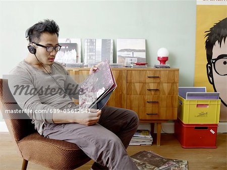 Man with headphones holding record Man with headphones holding record