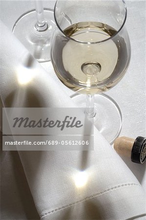 Glass of white wine and napkin Glass of white wine and napkin