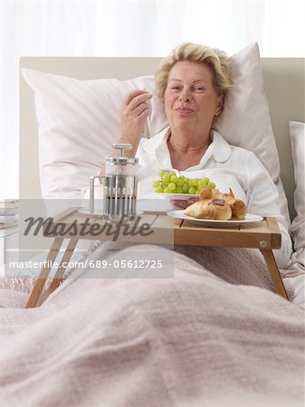 Woman having breakfast in bed