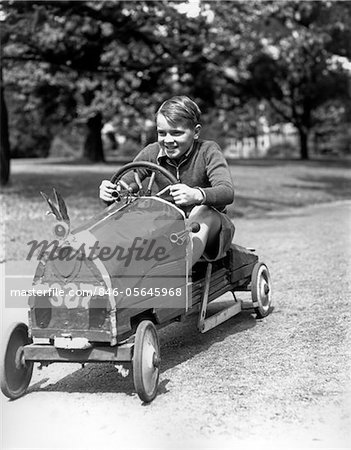 1930s BOY DRIVING HOME BUILT RACE CAR HOLDING STEERING WHEEL