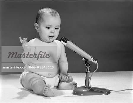 1960s BABY IN DIAPER SPEAKING INTO MICROPHONE