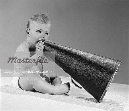 1960s BABY IN DIAPER SEATED HOLDING MEGAPHONE
