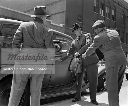 1940s PAIR OF GANGSTERS HOLDING UP MAN GETTING INTO CAR WITH BRIEFCASE