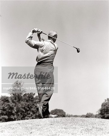 1940s - 1950s MAN PLAYING GOLF TEEING OFF SWINGING DRIVER CLUB