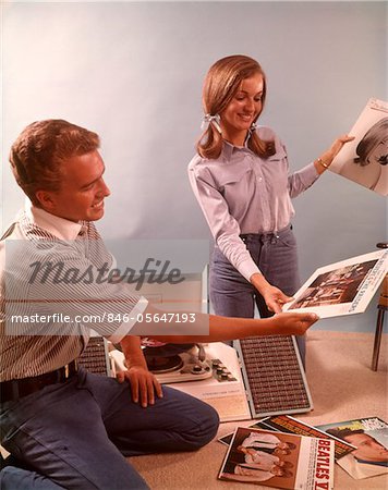 1960s SMILING TEENAGE COUPLE BOY GIRL SORTING LISTENING TO VINYL RECORD MUSIC ALBUMS