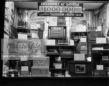 1940s WINDOW OF STORE SELLING RADIOS AND TELEVISIONS ADVERTISING A MILLION DOLLAR SALE