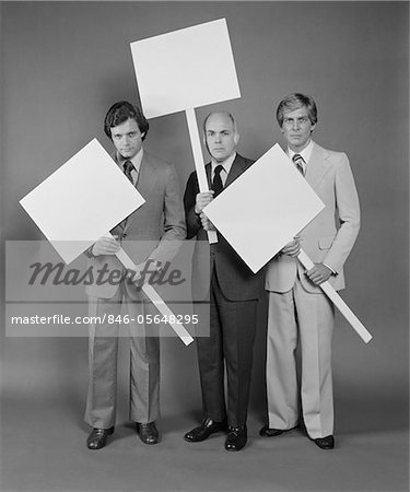 1970s TRIO OF BUSINESSMEN CARRYING BLANK SIGNS