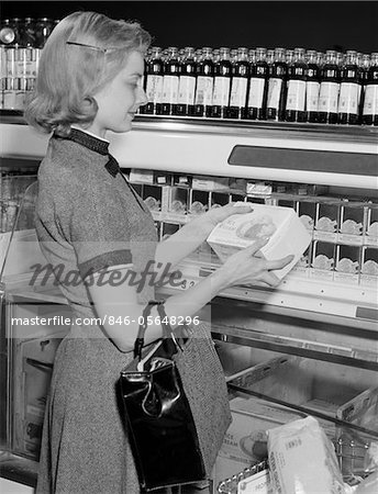 1950s - 1960s BLOND WOMAN SELECTING ICE CREAM FROZEN FOOD SECTION SUPERMARKET