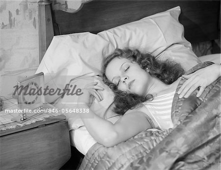 1930s WOMAN SLEEPING ASLEEP IN BED ALARM CLOCK ON NIGHT TABLE