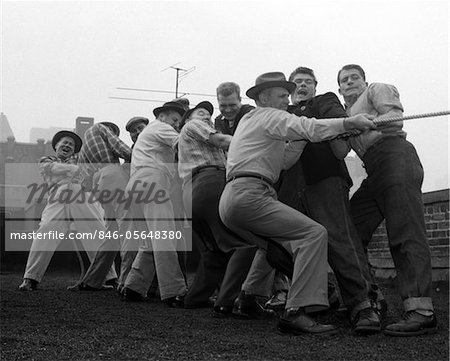 1950s MEN PLAYING TUG-OF-WAR