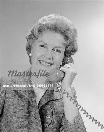 1960s PORTRAIT SMILING MATURE WOMAN TALKING ON TELEPHONE