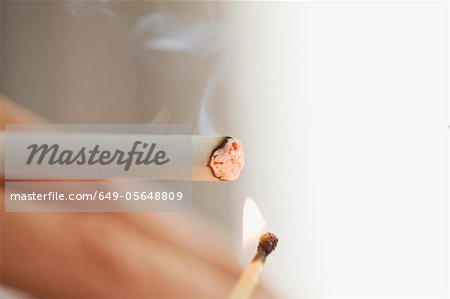 Close up of woman lighting cigarette